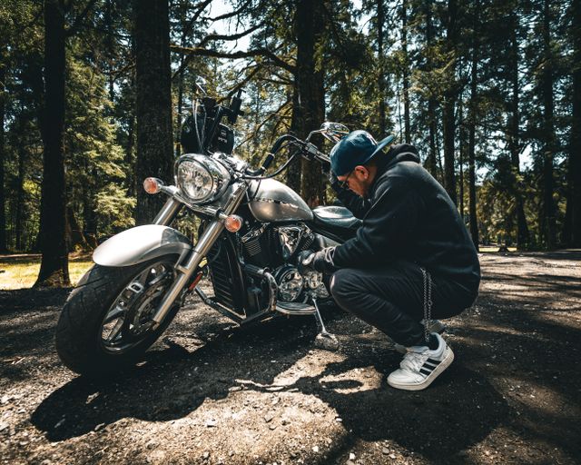 Rider checking motorcycle during basic maintenance