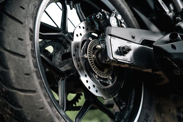 motorcycle disc brake close up showing ABS braking system safety feature performance control